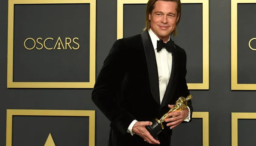 Brad Pitt z Oscarem w ręku, potwierdzając, czy Brad Pitt dostał Oscara.