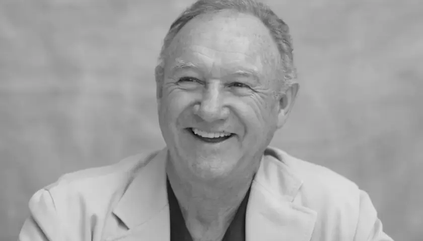 Uśmiechnięty Gene Hackman, którego już nie ma, w jasnej marynarce.