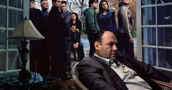Rodzina Soprano zakończenie. Tony Soprano siedzi, otoczony przez członków rodziny i współpracowników, w napiętej atmosferze.